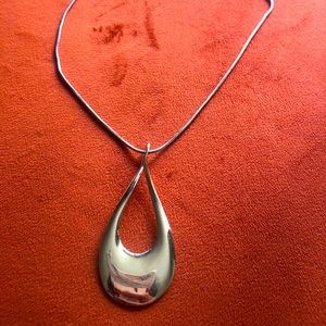 Gold teardrop cutout necklace.